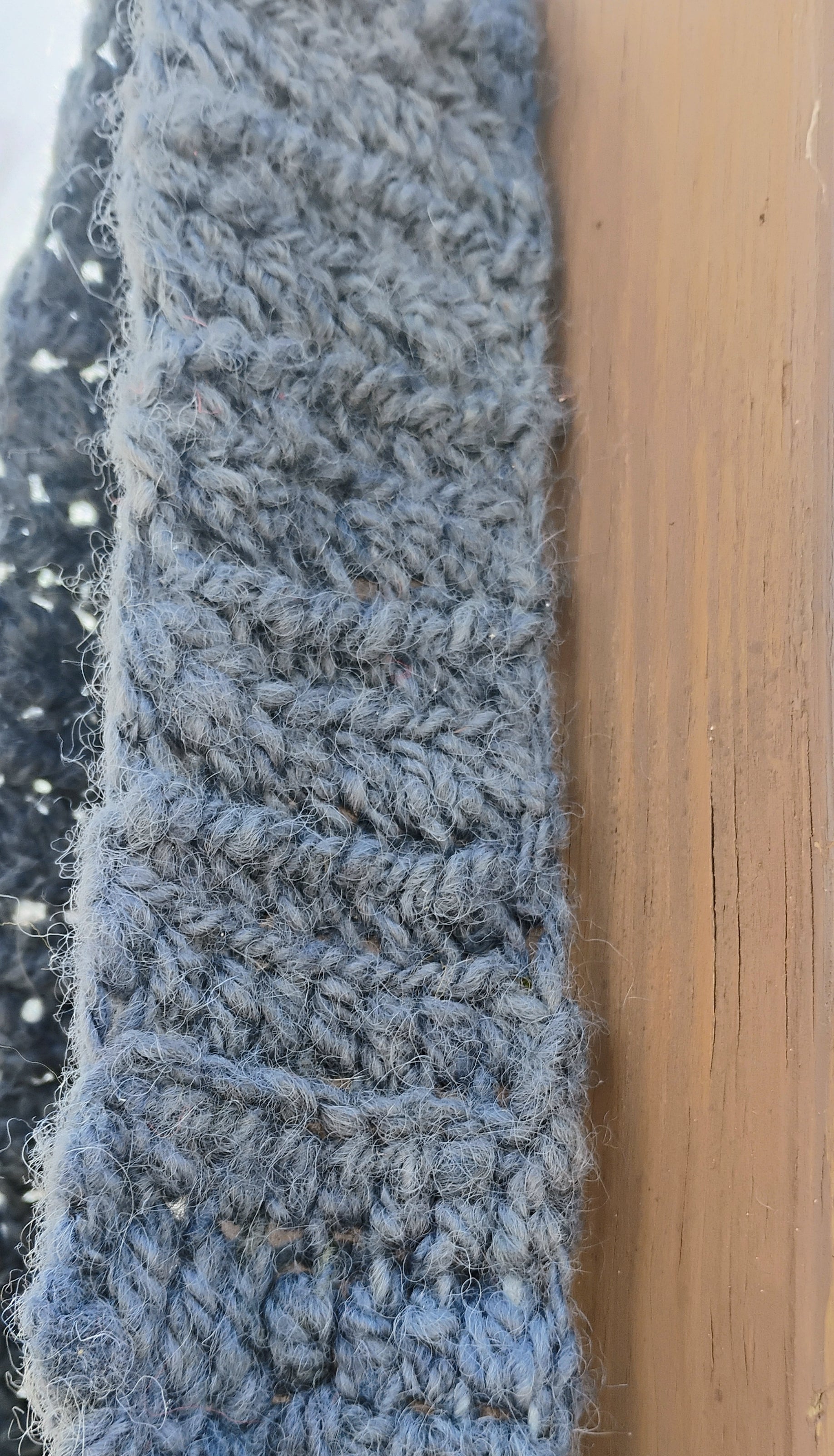 Close-up of wide 3 inch handspun wool crochet strap showing rich texture and hand-dyed denim blue color