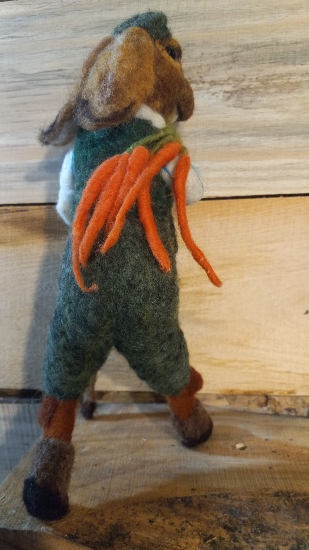 The Carrot Hunter needle felted rabbit sculpture full body side view with carrots and walking stick