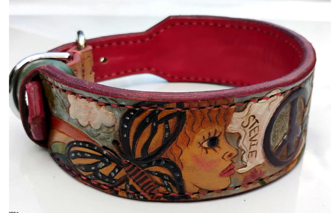 Close-up detail of hand-tooled dog collar showing butterfly and woman portrait motif